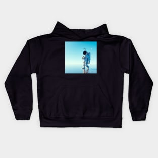 Astronaut walking in a blue ocean Kids Hoodie